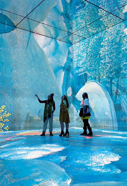 Visitors exploring immersive art installation at Frameless London.