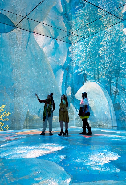 Visitors exploring immersive art installation at Frameless London.