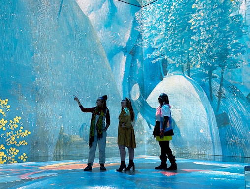 Visitors exploring immersive art installation at Frameless London.