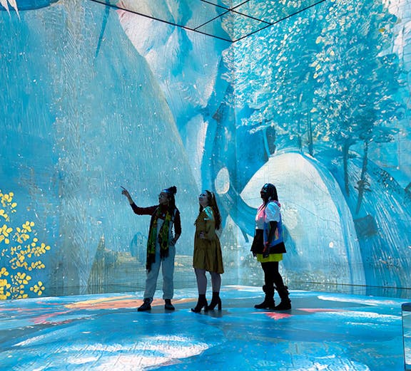 Visitors exploring immersive art installation at Frameless London.