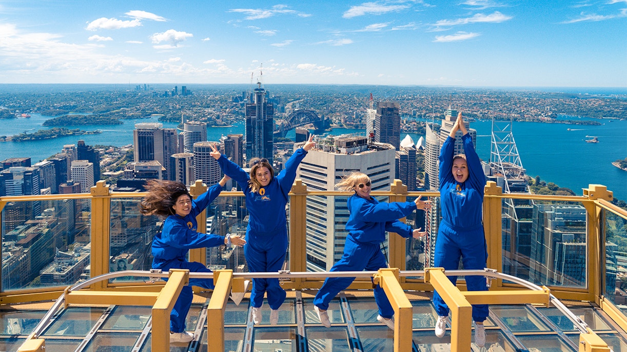 Group of people jumping in the air and enjoying the view from Sydney Eye Tower