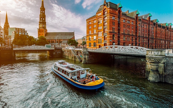 Boat cruising through Hamburg's Speicherstadt district on a 2-hour harbor tour.