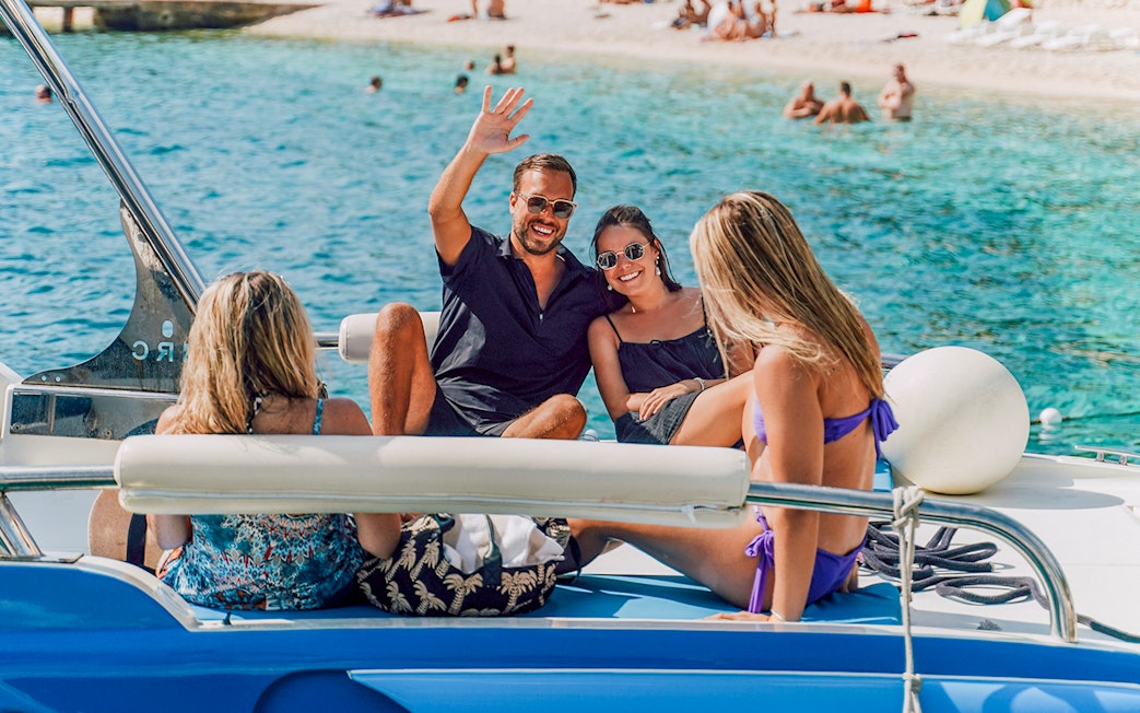 Guests relaxing on a speedboat in Blue Lagoon, enjoying the sunny day.