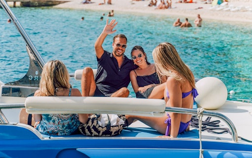 Guests relaxing on a speedboat in Blue Lagoon, enjoying the sunny day.