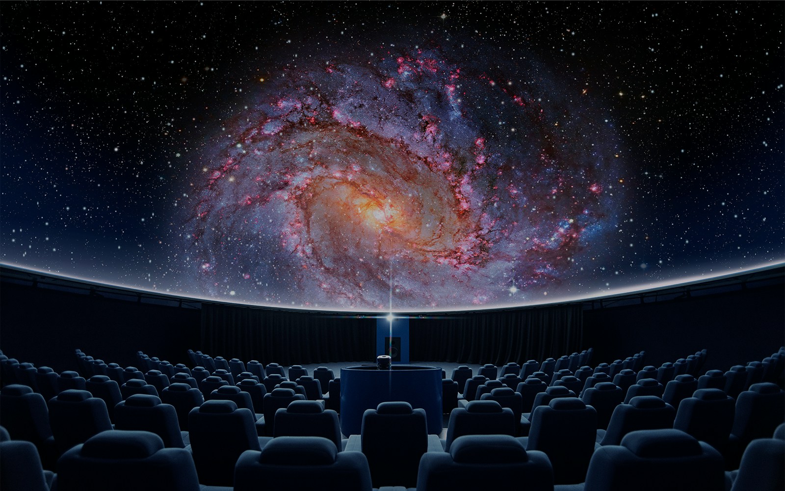 Peter Harrison Planetarium dome at Royal Observatory Greenwich with starry night sky.