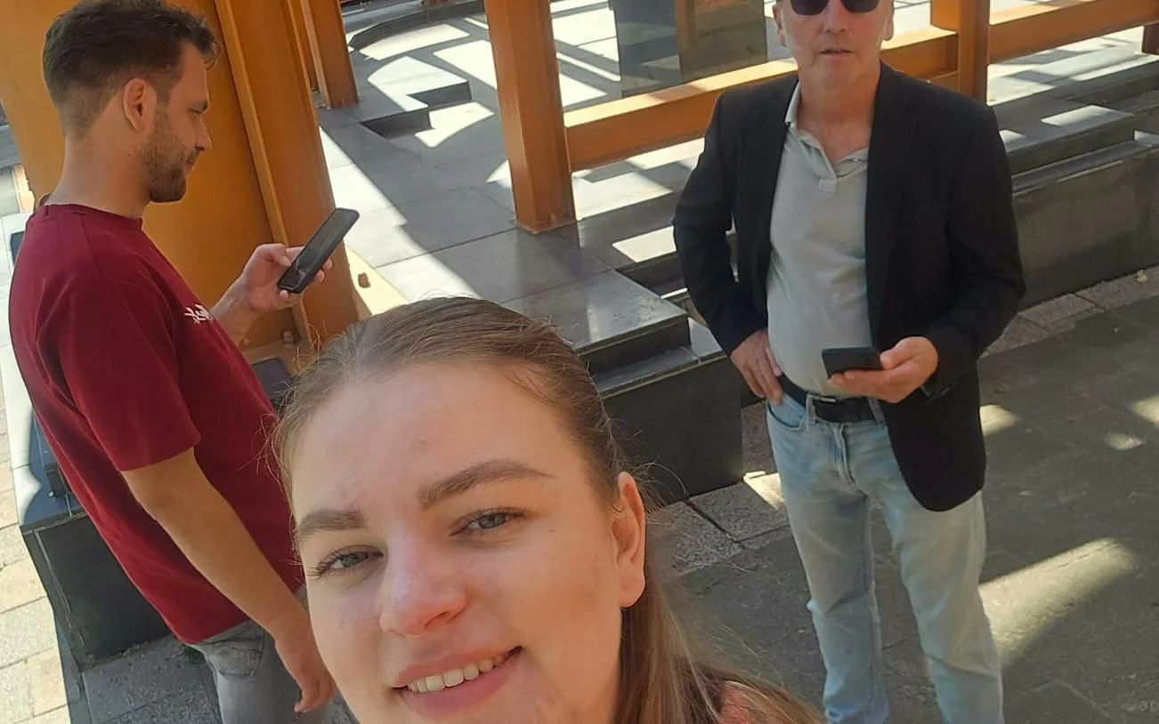 People using smartphones during a self-guided city exploration game in Rotterdam.