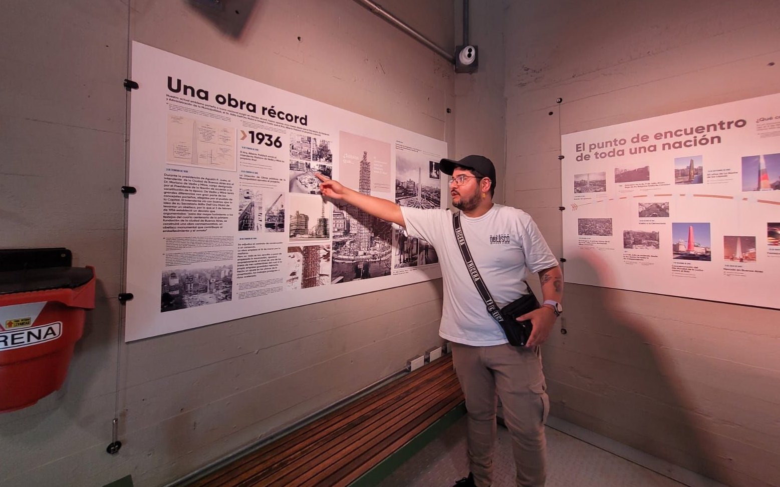 Tourist with guide explaining history at Obelisco de Buenos Aires, Argentina.