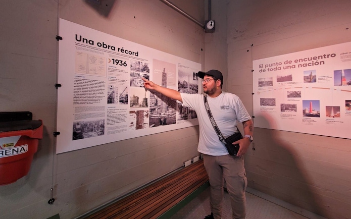 Tourist with guide explaining history at Obelisco de Buenos Aires, Argentina.