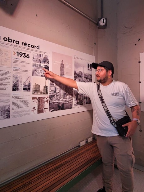 Tourist with guide explaining history at Obelisco de Buenos Aires, Argentina.