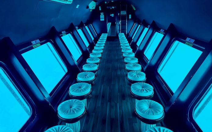 Viewing area inside Royal Seascope Submarine, Hurghada, with rows of seats and large windows.