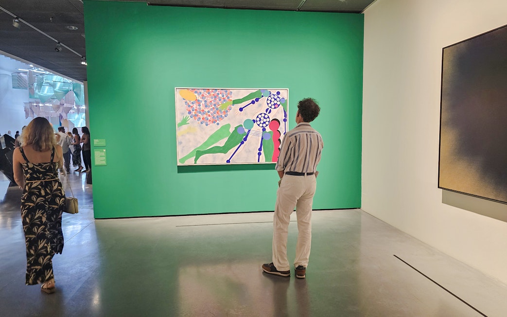 Visitors viewing modern art at Centre Pompidou Malaga exhibition interior.