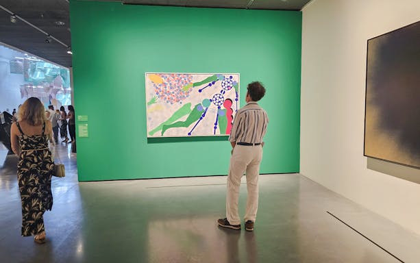 Centre Pompidou Malaga interior with visitors exploring modern art exhibition displays.