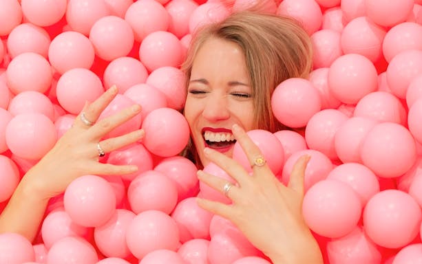 Guests enjoying pink ball pit at Immersive Bubble Planet in Singapore.