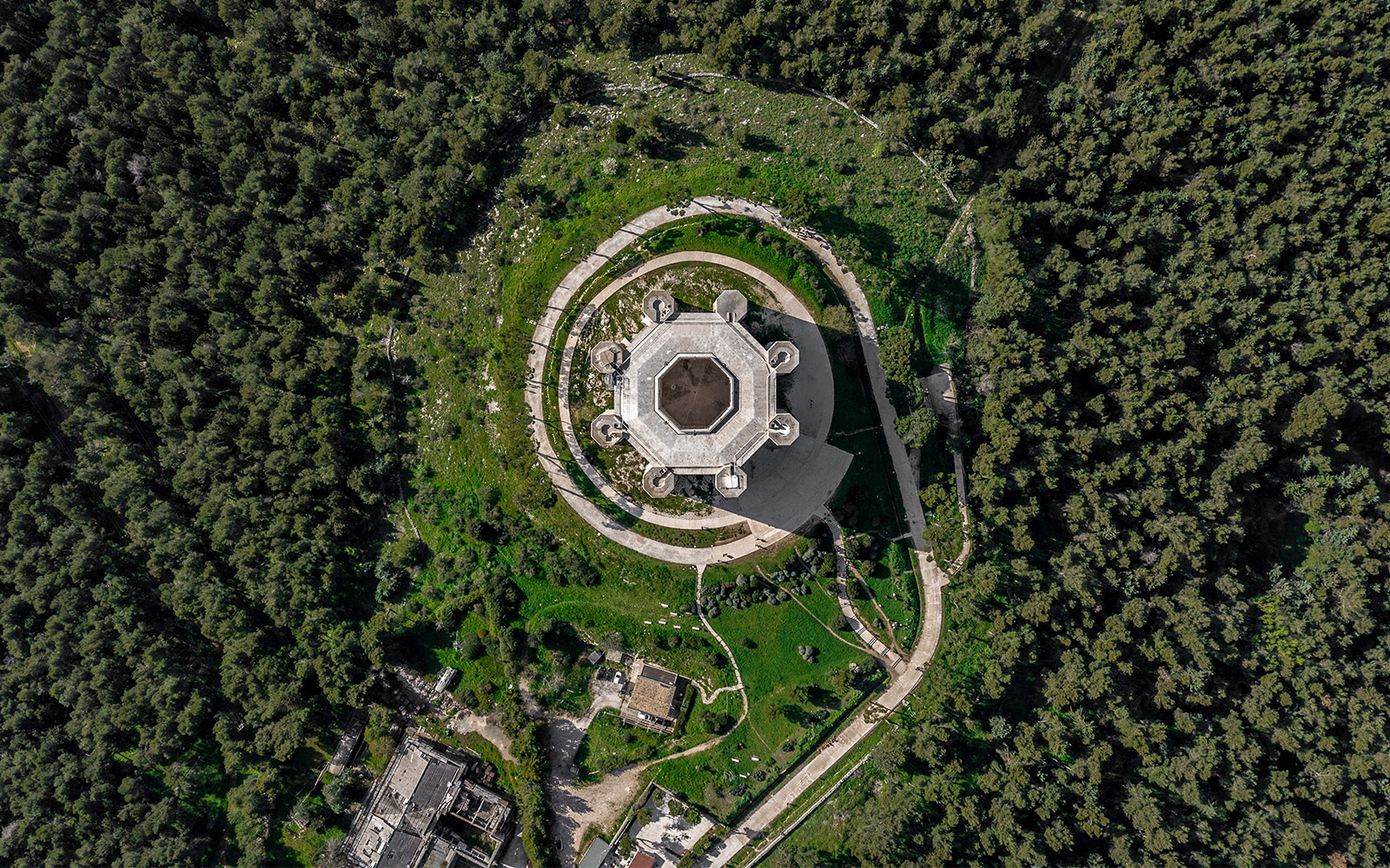 Aerial view of Castel del Monte surrounded by greenery in Andria, Italy.