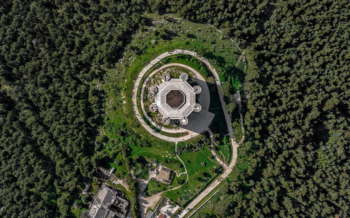 Aerial view of Castel del Monte surrounded by greenery in Andria, Italy.