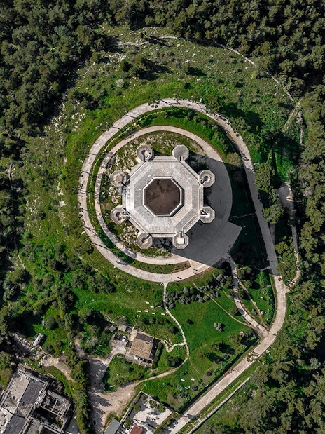 Aerial view of Castel del Monte surrounded by greenery in Andria, Italy.