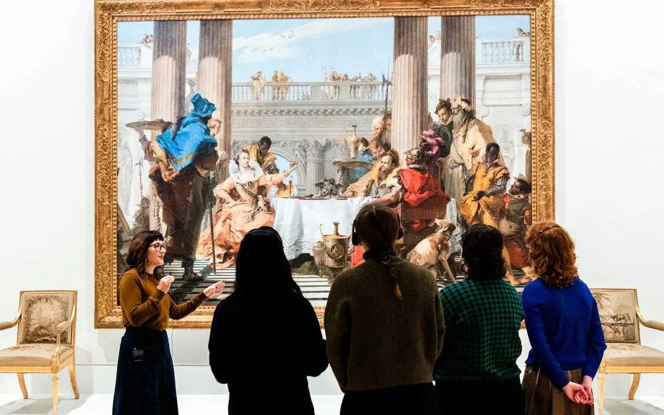 Visitors viewing a large painting during the Best of NGV Experiences Tour at the National Gallery of Victoria.