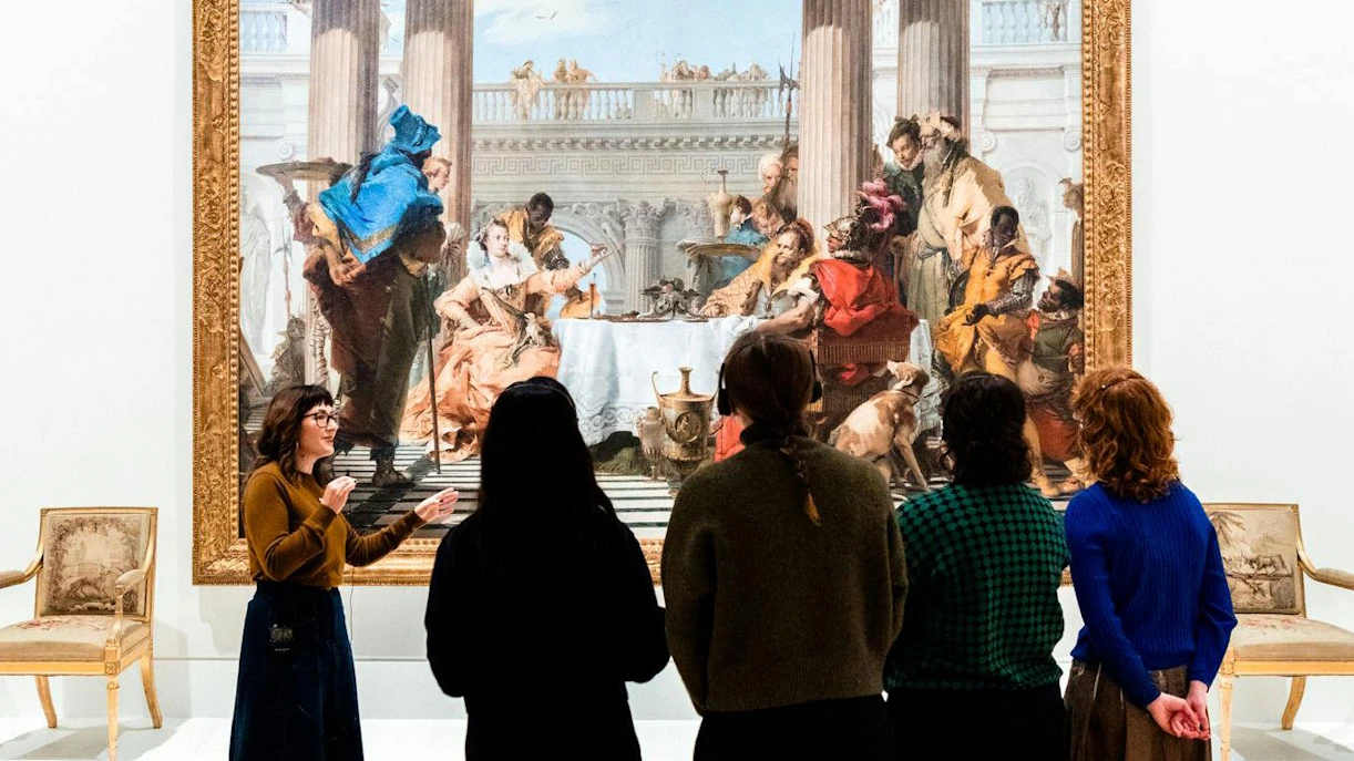 Visitors viewing a large painting during the Best of NGV Experiences Tour at the National Gallery of Victoria.