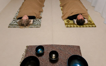Participants in lying-down meditation during a private Japanese sound bath in Kyoto.