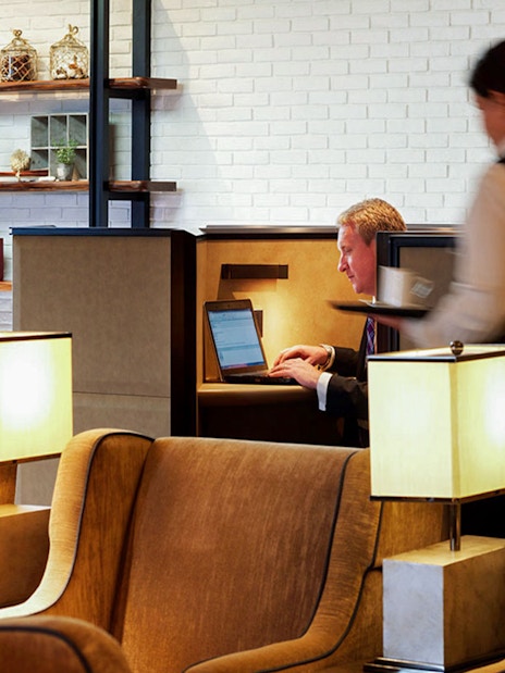 Waitress serving guest at Plaza Premium Lounge, Heatherow Airport, London