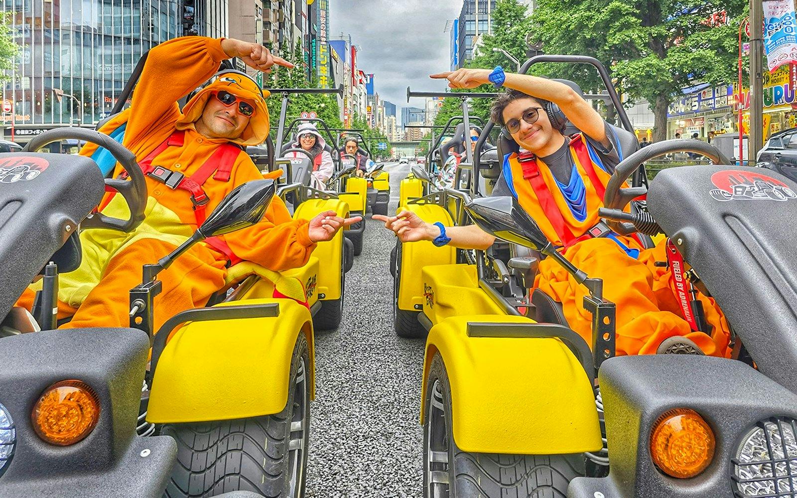 Participants in costumes driving go-karts on the Uptown Go Kart Tour in a city street.