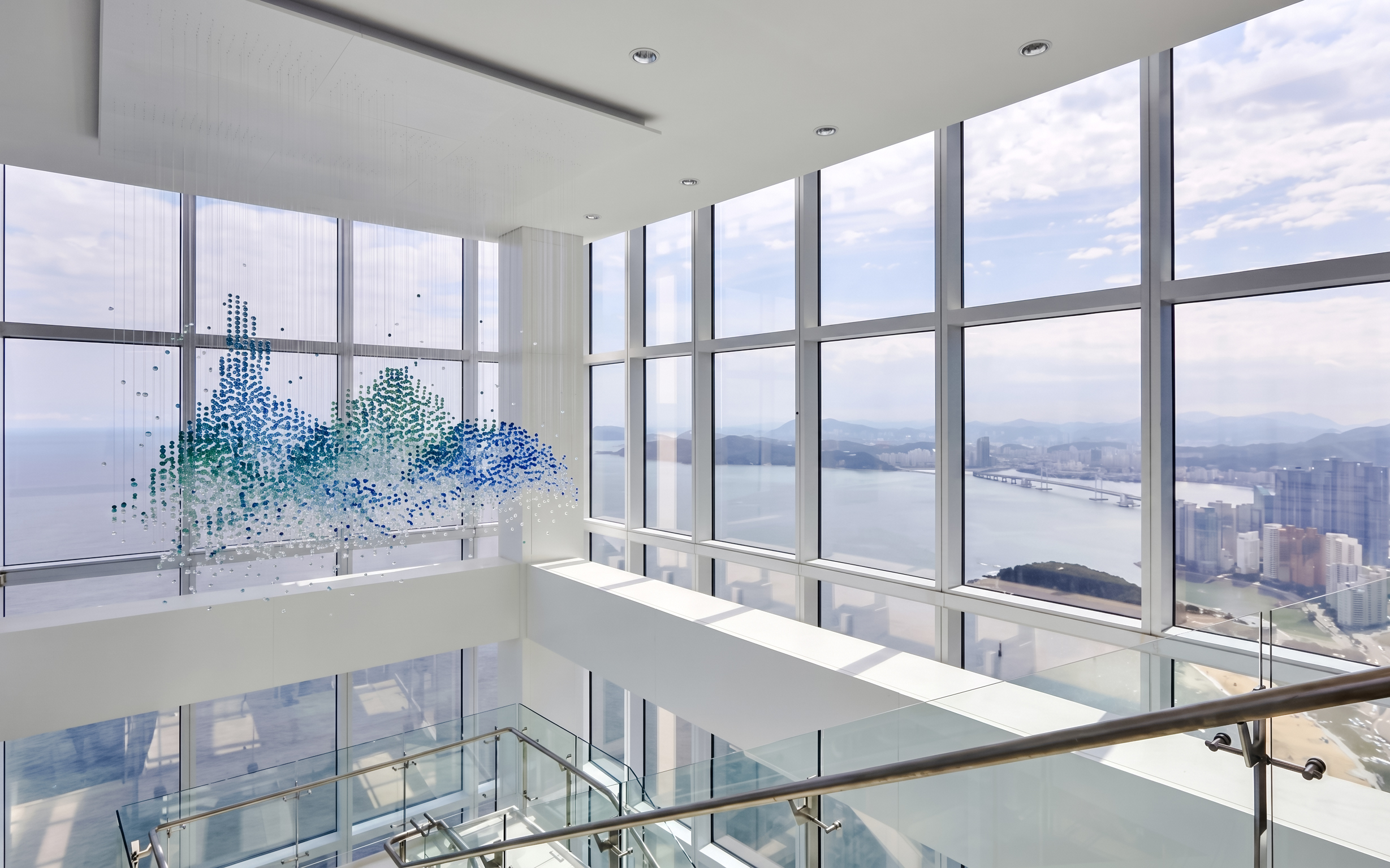Observation deck view from BUSAN X The SKY with cityscape and ocean.