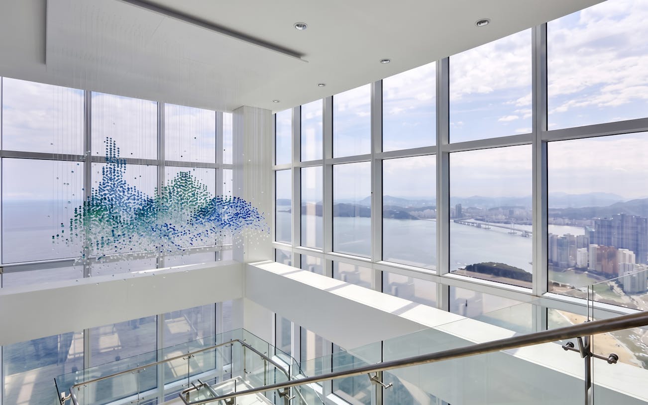 Observation deck view from BUSAN X The SKY with cityscape and ocean.