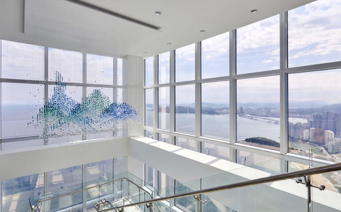 Observation deck view from BUSAN X The SKY with cityscape and ocean.
