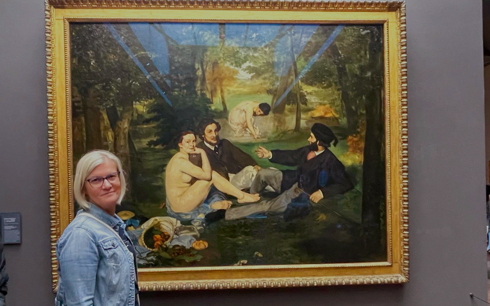 Orsay Museum visitor viewing "The Luncheon on the Grass" painting.