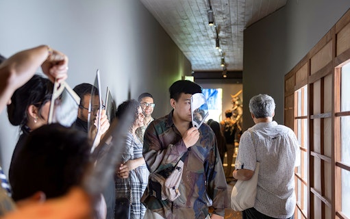 Visitors exploring exhibits at the Samurai Museum, engaging with interactive displays.