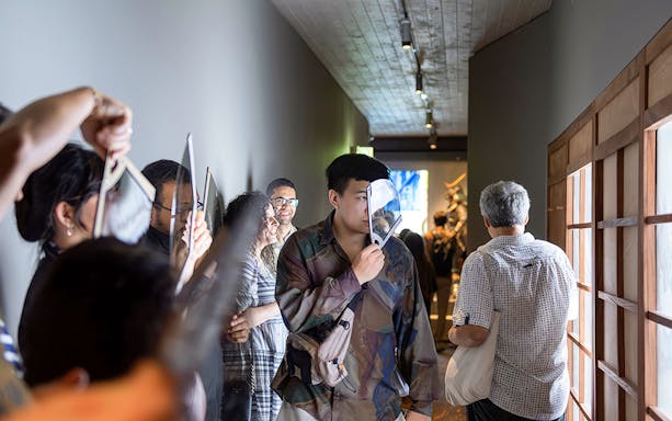 Visitors exploring exhibits at the Samurai Museum, engaging with interactive displays.