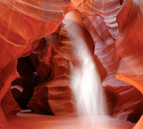 Sunbeam illuminating red sandstone walls in Upper Antelope Canyon, Page, Arizona.