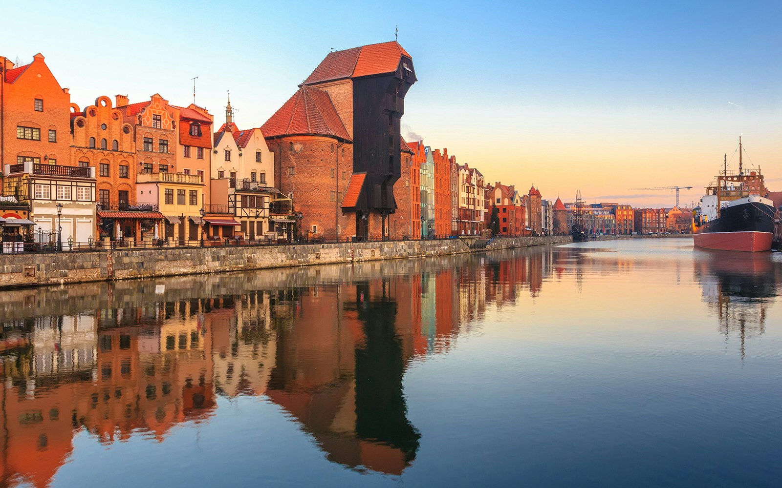Gdansk waterfront with historic buildings and pirate ship for lunch cruise to Westerplatte.