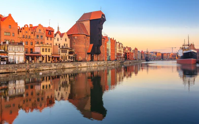 Gdansk waterfront with historic buildings and pirate ship for lunch cruise to Westerplatte.