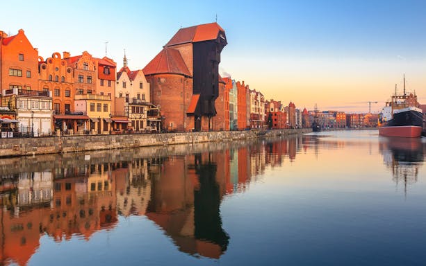 Gdansk waterfront with historic buildings and pirate ship for lunch cruise to Westerplatte.