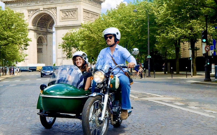 Sidecar tour passing the Arc de Triomphe in Paris.