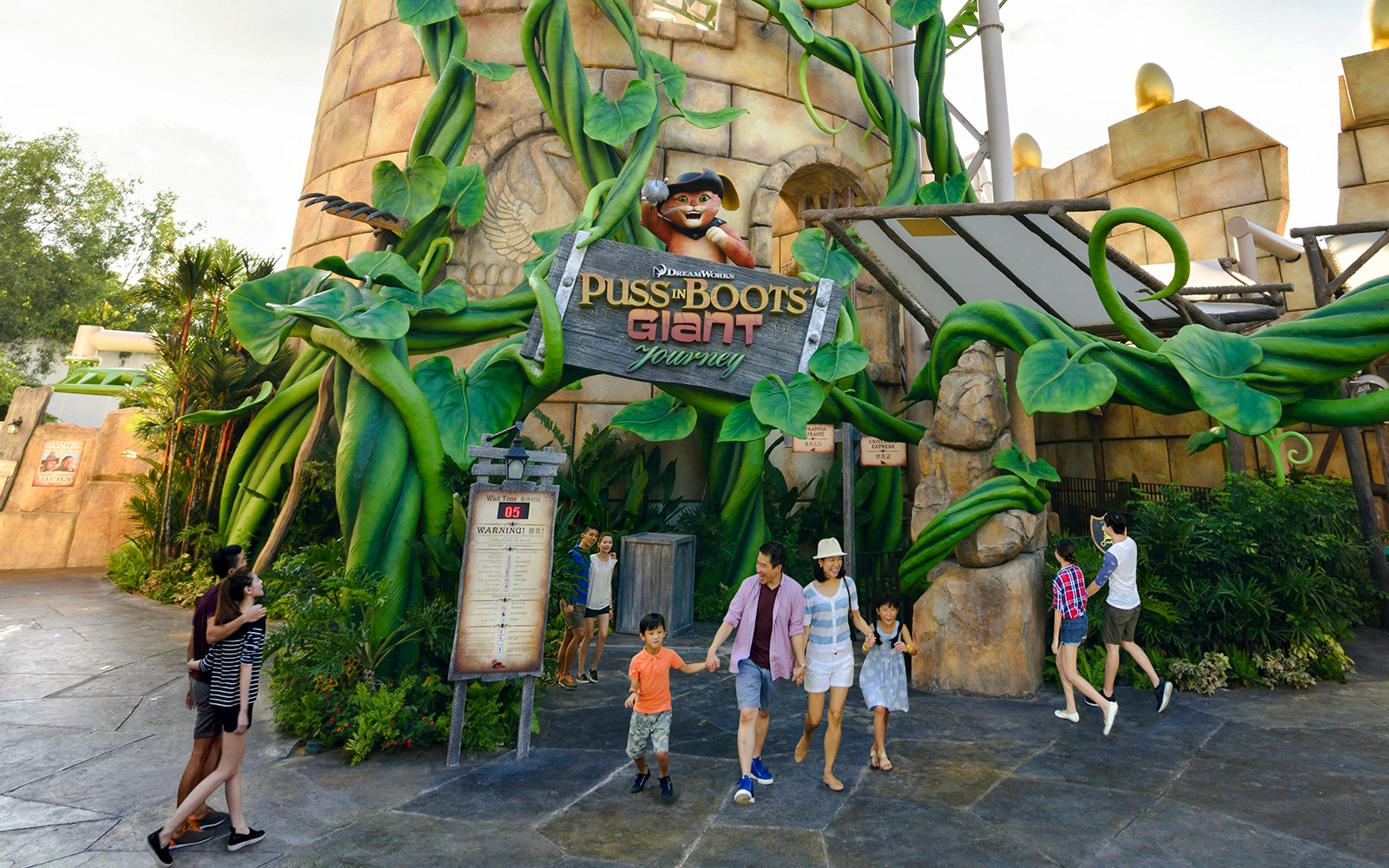 Puss in Boots ride at Universal Studios Singapore with giant beanstalk and castle backdrop.