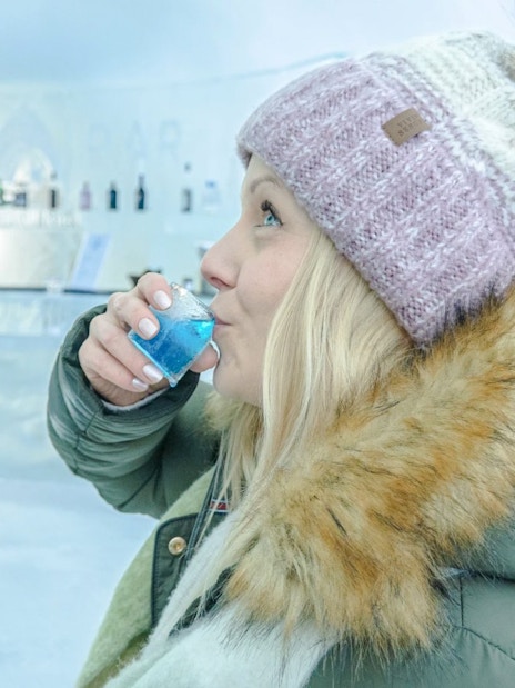 Guests enjoying drinks at the ice bar inside Arctic SnowHotel.