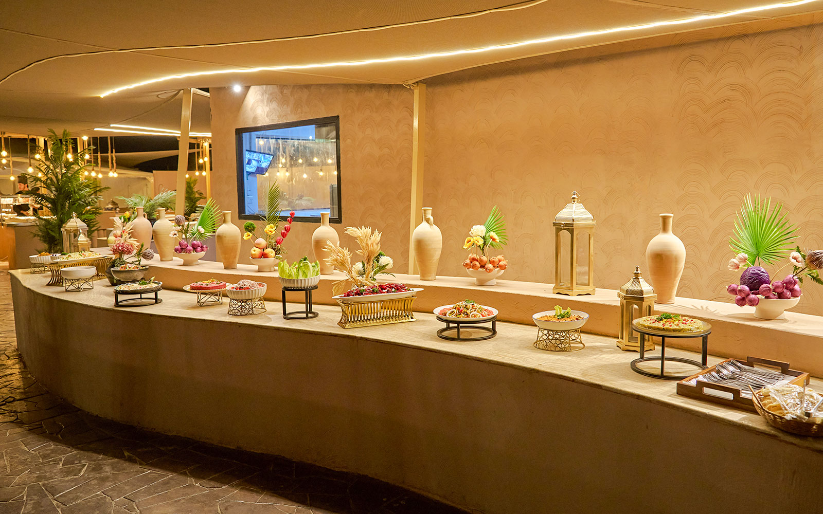 Buffet spread at Noble Camp Desert Safari with various dishes and decorative elements.