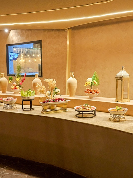 Buffet spread at Noble Camp Desert Safari with various dishes and decorative elements.
