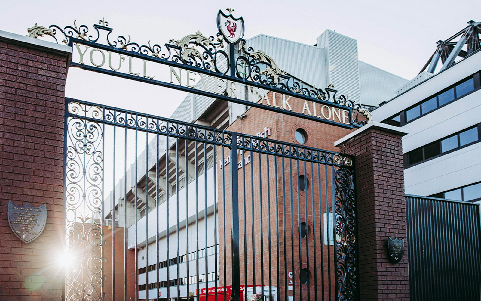 Shankly Gates at Anfield Stadium, Liverpool, with "You'll Never Walk Alone" sign.