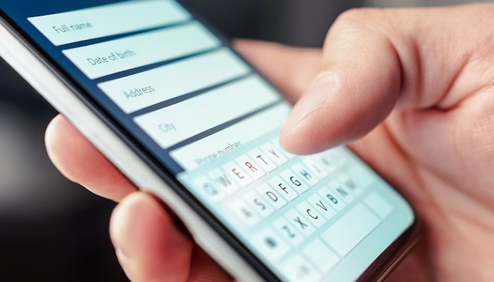 Person entering tour booking details on smartphone.