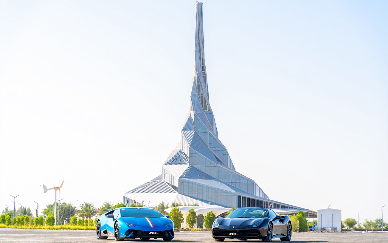 Supercars parked in front of Dubai Innovation Centre for self-drive tour.