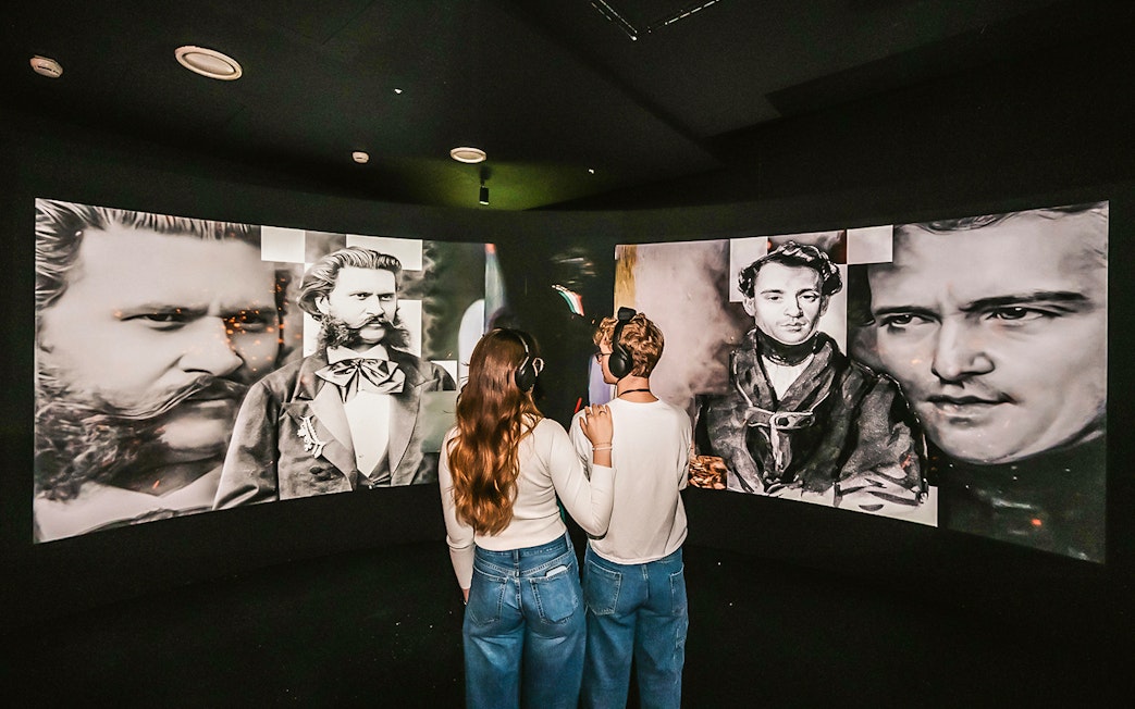Visitors viewing Johann Strauss exhibits at the Vienna Immersive Museum.