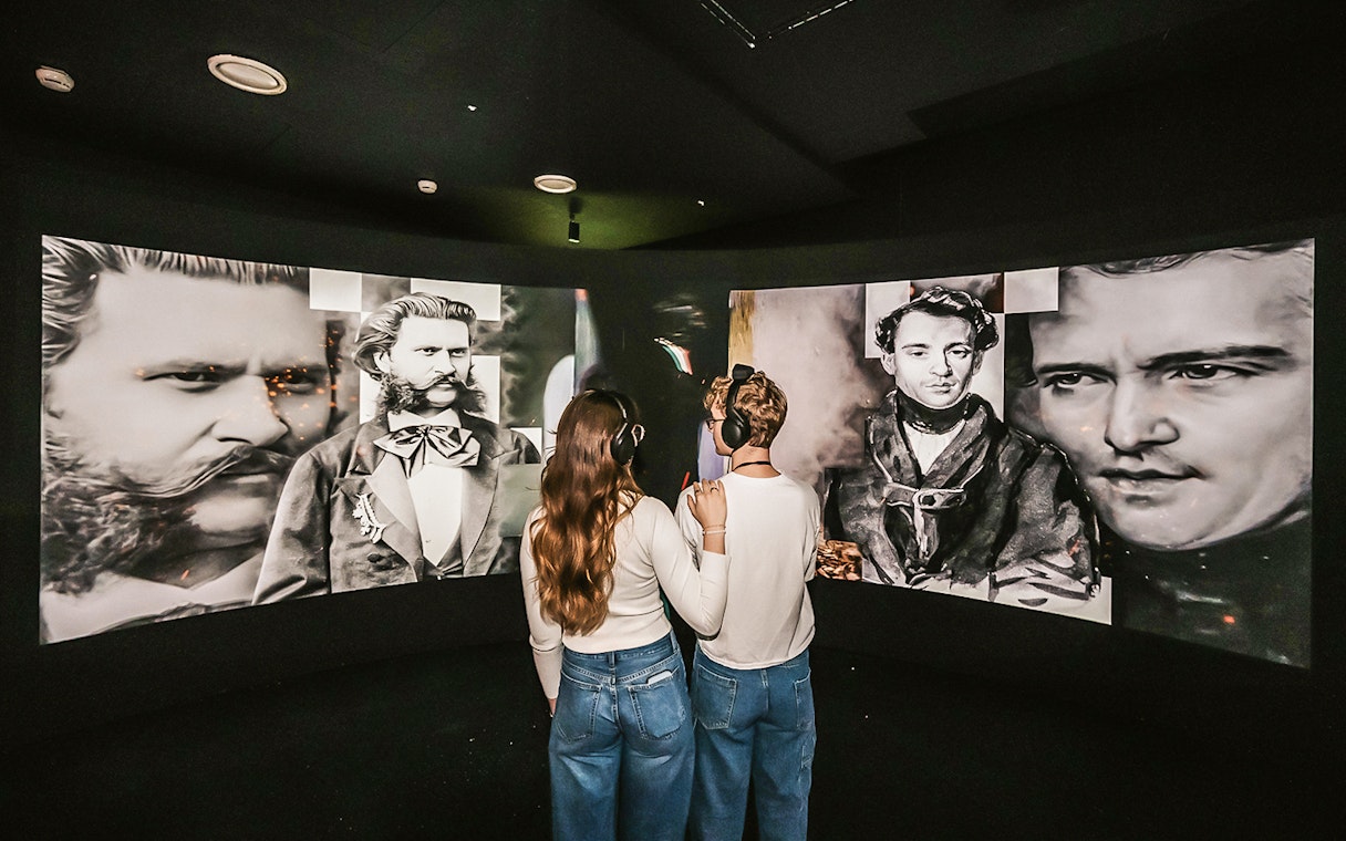 Visitors viewing Johann Strauss exhibits at the Vienna Immersive Museum.