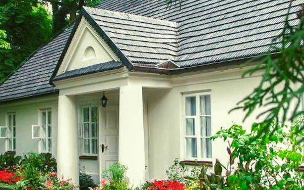 Chopin's birthplace in Żelazowa Wola, Poland, surrounded by lush gardens.