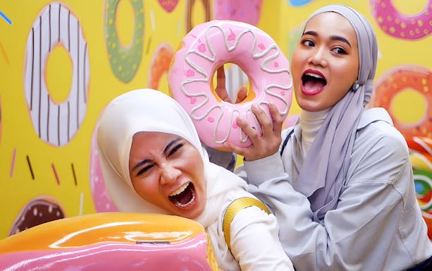 Visitors enjoying donut-themed attraction at Wonderpark Melaka.
