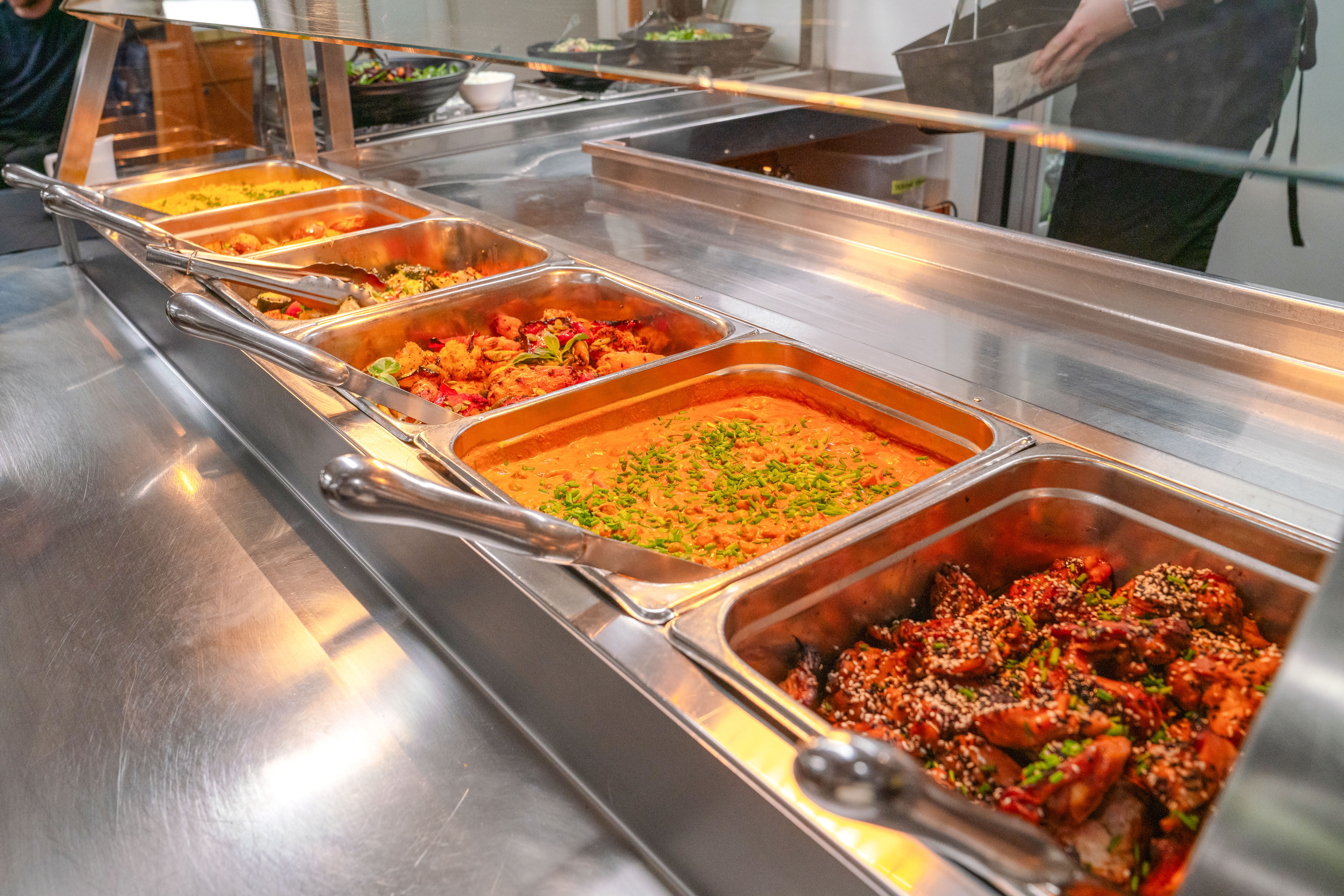 Buffet with curries and roasted vegetables on wilderness cruise.