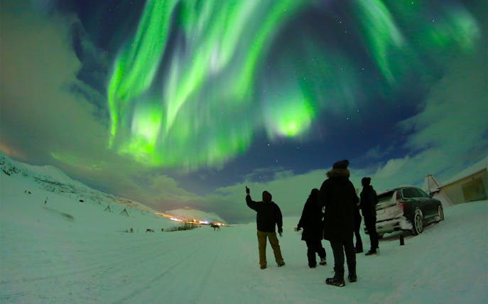 People watching Northern Lights with guide in Tromso, Norway.