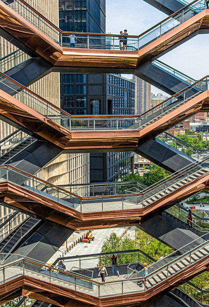 Vessel structure in New York with people walking on interconnected staircases.